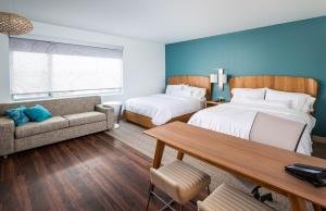 a hotel room with two beds and a couch at Element Nashville Airport in Nashville +22 photos