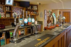 a bar with two faucets on a counter at The Feathers in Ruthin