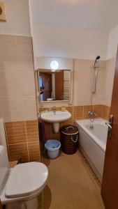 a bathroom with a toilet and a sink and a tub at BH & Semiramida Ski Apartment in Borovets