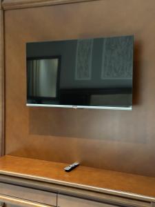 a remote control sitting on a counter with a television at Mir Luxe Plaza in Tashkent