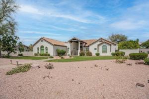 a large white house with a gravel driveway at Stunning 5 Bed Luxury Oasis Heated Pool Hot Tub in Scottsdale