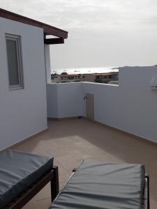 an empty room with two beds and a window at Cala da Lua apartments in Sal Rei