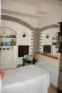 a bedroom with a white bed in a room at Millenium Palace in Ohrid