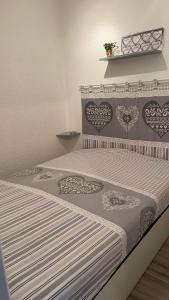 Un dormitorio con una cama con corazones. en La Méa en Barcelonnette