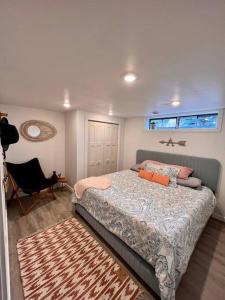 a bedroom with a bed and a chair and a window at Mid Century Modern Montana Dream Home in Butte