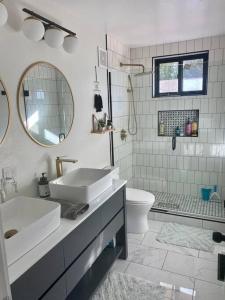 uma casa de banho com um lavatório, um WC e um espelho. em Mid Century Modern Montana Dream Home em Butte