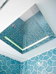 a bathroom with blue and white tiles on the floor at Villa Nannina in Positano