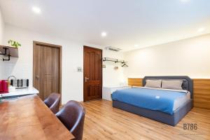 a bedroom with a bed and a table and chairs at B786 Airport Apartment in Ho Chi Minh City