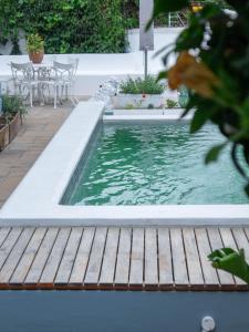 a pool in a backyard with a wooden deck at Charming Heritage Villa Tamboerskloof in Cape Town