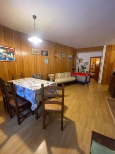 a living room with a table and chairs and a couch at Casa da Roberto in Roccaraso