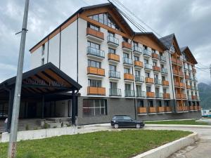 a building with a car parked in front of it at New Gudauri Twins in Gudauri