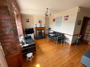 ein Wohnzimmer mit Couch und Kamin in der Unterkunft Lovely apartment overlooking the harbour and bay in Ardglass + 21 Fotos
