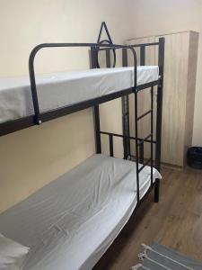 a couple of bunk beds in a room at Like Home Rooms in Almaty