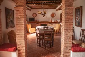 a kitchen and dining room with a table and chairs at Cortijo San Rafael in Constantina