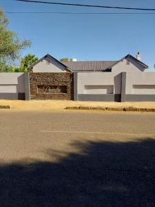 a building with a sign on the side of a street at Precious Estates Pearls in Zeerust
