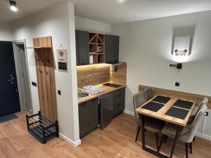 a small kitchen with a table and a small table and a table and a kitchen at Apartman Mist - Bela Reka Kopaonik in Brzeće