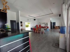 a kitchen and living room with a table and chairs at SCIA Hills Exclusive 25pax WiFi Netflix HBO Videoke Pool in Oslob