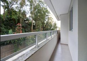 a balcony with a view of trees and bushes at Quality Place Apartments by BnbHost in Sao Paulo