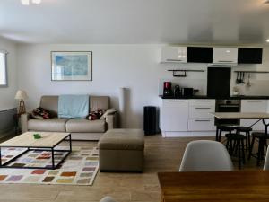 a living room with a couch and a table at Appartement Urt, 3 pièces, 8 personnes - FR-1-239-795 in Urt