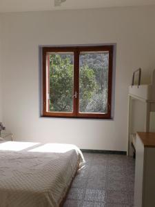 a bedroom with a bed and a window at B&B La Quercia in San Gregorio