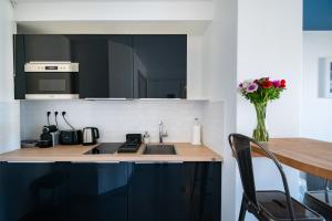 a kitchen with a sink and a vase of flowers at La Maioneta Carré d'Or in Nice