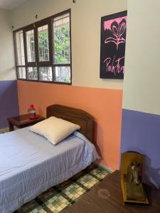 a bedroom with a bed and a window at El Pueblito in Cochabamba