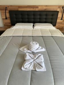 a bed with two towels and a bow on it at Paradise Garajau in Garajau