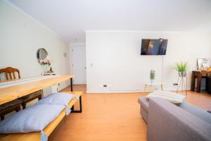 a living room with two couches and a table at Full departamento, Metro Manquehue, Las Condes in Santiago