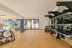 a gym with treadmills and machines in a room at Brand New Iyari Condo Pool Whirlpool BBQ Gym in Nuevo Vallarta 