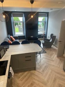 a living room with a couch and a table and chairs at Springlea in Oban