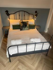 a large bed with white sheets and pillows at Springlea in Oban