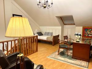 a living room with a bed and a chair and a lamp at Los Sauces, adosado a 10 minutos de Oviedo y 15 de Gijon in Llanera