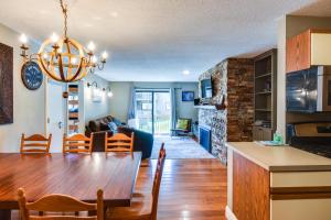 a dining room and living room with a dining table at Ski-In and Out and Golf Condo with A and C at Holiday Valley! in Ellicottville