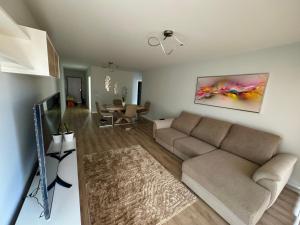 a living room with a couch and a table at Paradise Garajau in Garajau