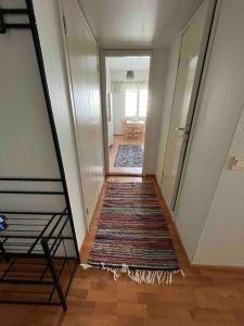 a hallway with a rug on the floor in a house at Majoitusta 4:lle Pori in Pori