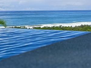 a swimming pool with a view of the ocean at Vista Naranja Ocean View House in Mal País