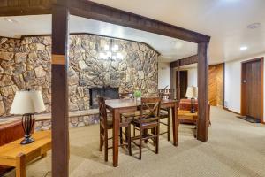 a dining room with a stone wall at Cozy Condo with Fireplace - Near Brian Head Resort! in Brian Head