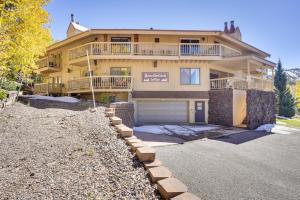 a large house with a garage in front of it at Cozy Condo with Fireplace - Near Brian Head Resort! in Brian Head