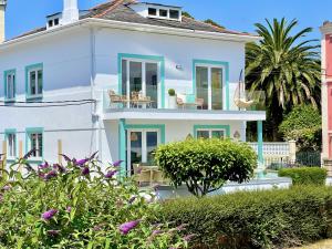 a large white house with a balcony at The Cliffs - VilaTurquesa A in Viveiro