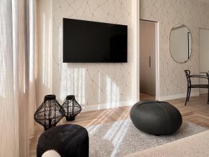 TV at/o entertainment center sa YLS Luxury Suites