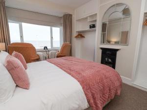 a bedroom with a large bed and a window at Sea View House in Hornsea