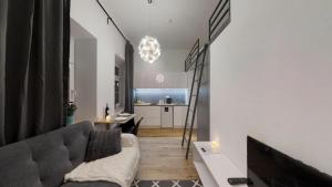 a living room with a couch and a table at APARTHOTEL TECTUM in Wrocław