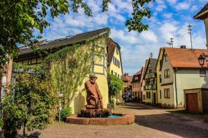 a statue of a man sitting on a fountain in a street at Apartment am Schloss in Lohr am Main