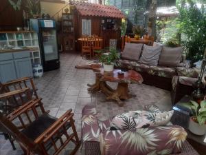 a living room with a couch and chairs and a table at Coyaba Tropical Elegant Adult Guesthouse in Manuel Antonio