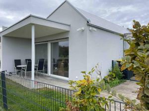 a white house with a table and chairs at Wohnung mit Garten Nähe Legoland in Leipheim