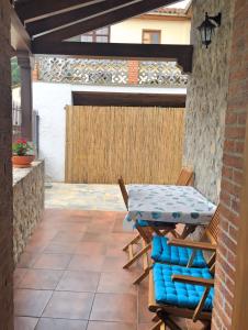 a patio with a table and chairs on a patio at La Fragua in Nueva de Llanes