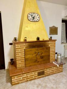 a fireplace with a clock on top of it at Anna&Franco Guest House in Isernia +19 photos