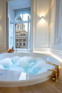 a bath tub with a view of a building at Jacuzzi Basilica view in Budapest