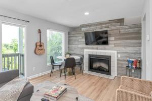 a living room with a table and a fireplace at Nashville Oasis Walk to Broadway with POOL, Parking, Gym and Patio in Nashville