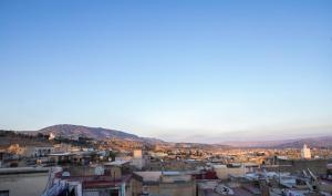 a view of a city with mountains in the background at Riad Fes Tala in Fez